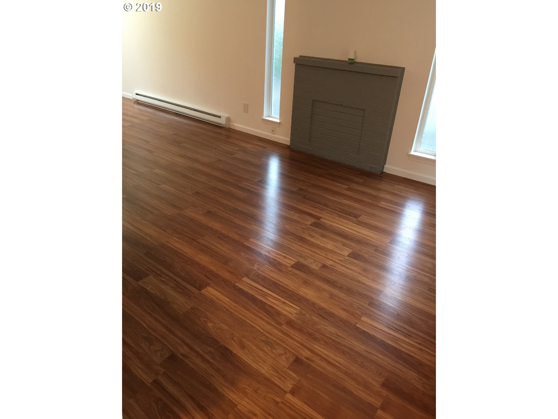 9733 Southeast Foster Road Portland, OR 97266 - Photo 7 of 16 a view of a hallway with wooden floor