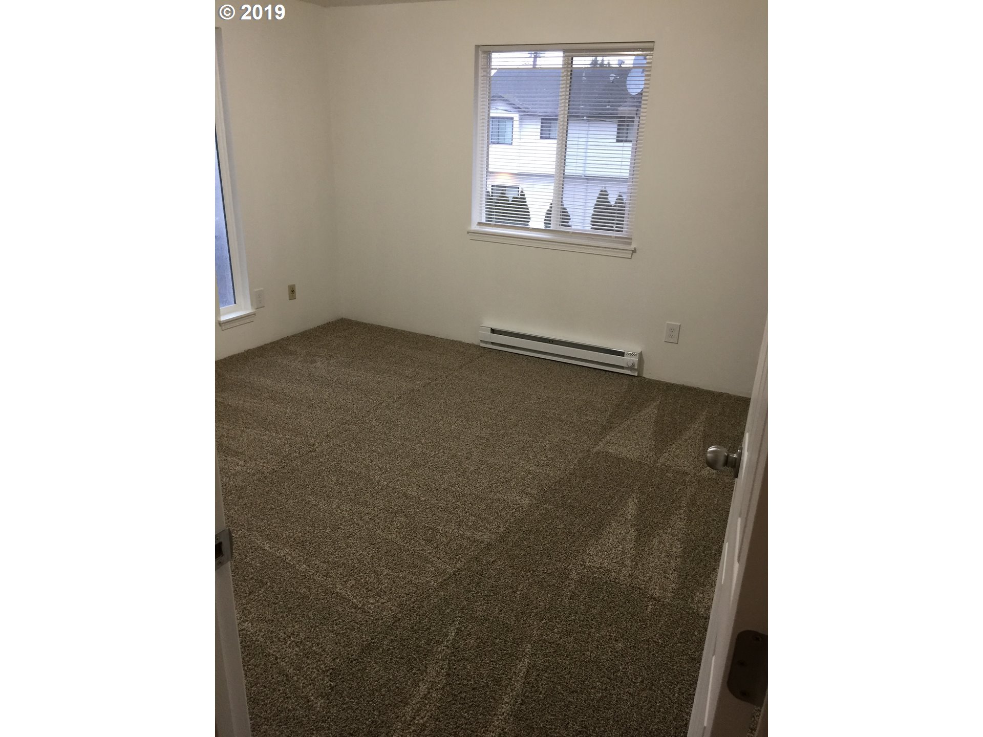 9733 Southeast Foster Road Portland, OR 97266 - Photo 10 of 16 a view of an empty room with window