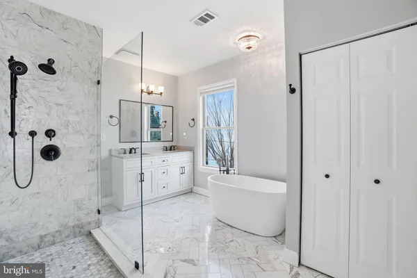 a bathroom with a bathtub shower sink and toilet