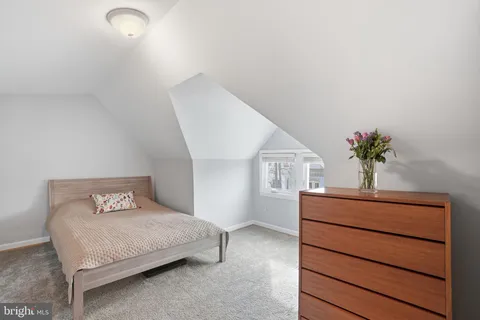 a bedroom with a bed and a potted plant