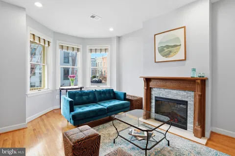 a living room with furniture and a fireplace