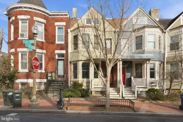 a front view of a residential apartment building with a yard