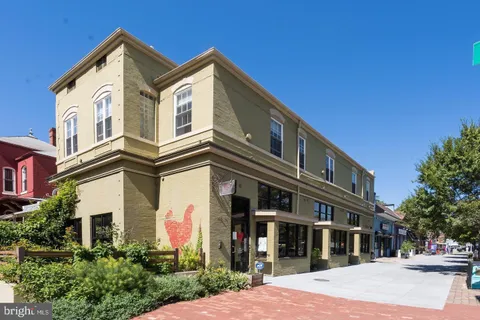 a front view of a building with traffic signal lights