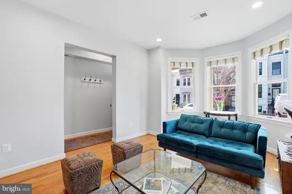 a living room with furniture and a book shelf
