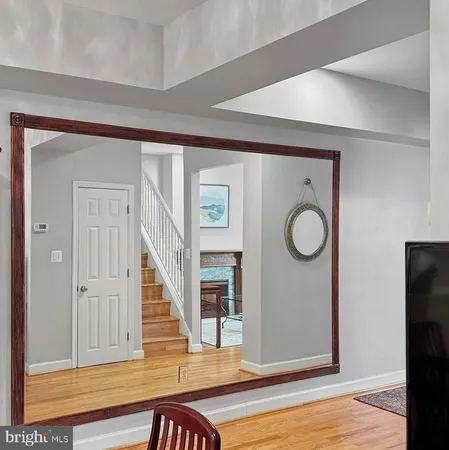 a view of a livingroom with wooden floor and staircase
