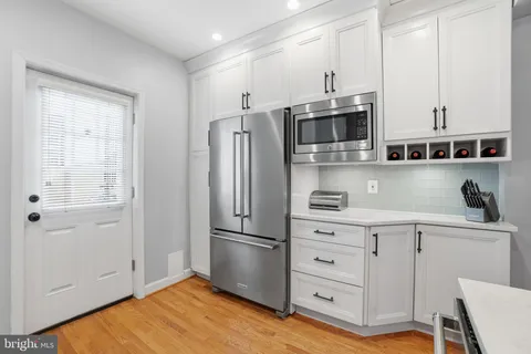 a kitchen with stainless steel appliances a refrigerator sink and microwave