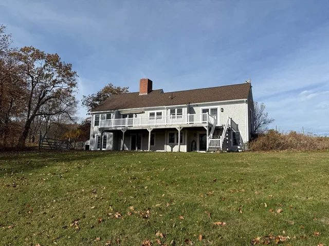 a view front of house with yard and trees in the background