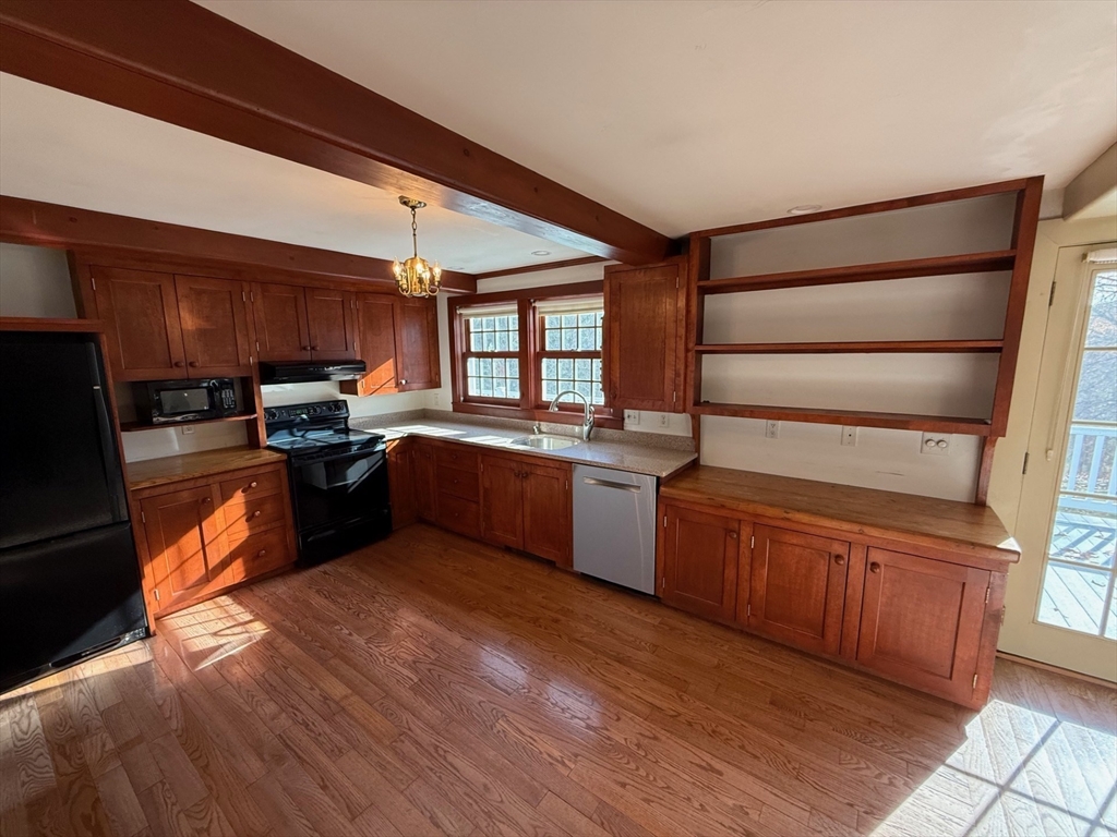 94 West Princeton Road Westminster, MA 01473 - Photo 9 of 26 a kitchen with stainless steel appliances kitchen island granite countertop wooden cabinets a sink a stove a dining table and chairs