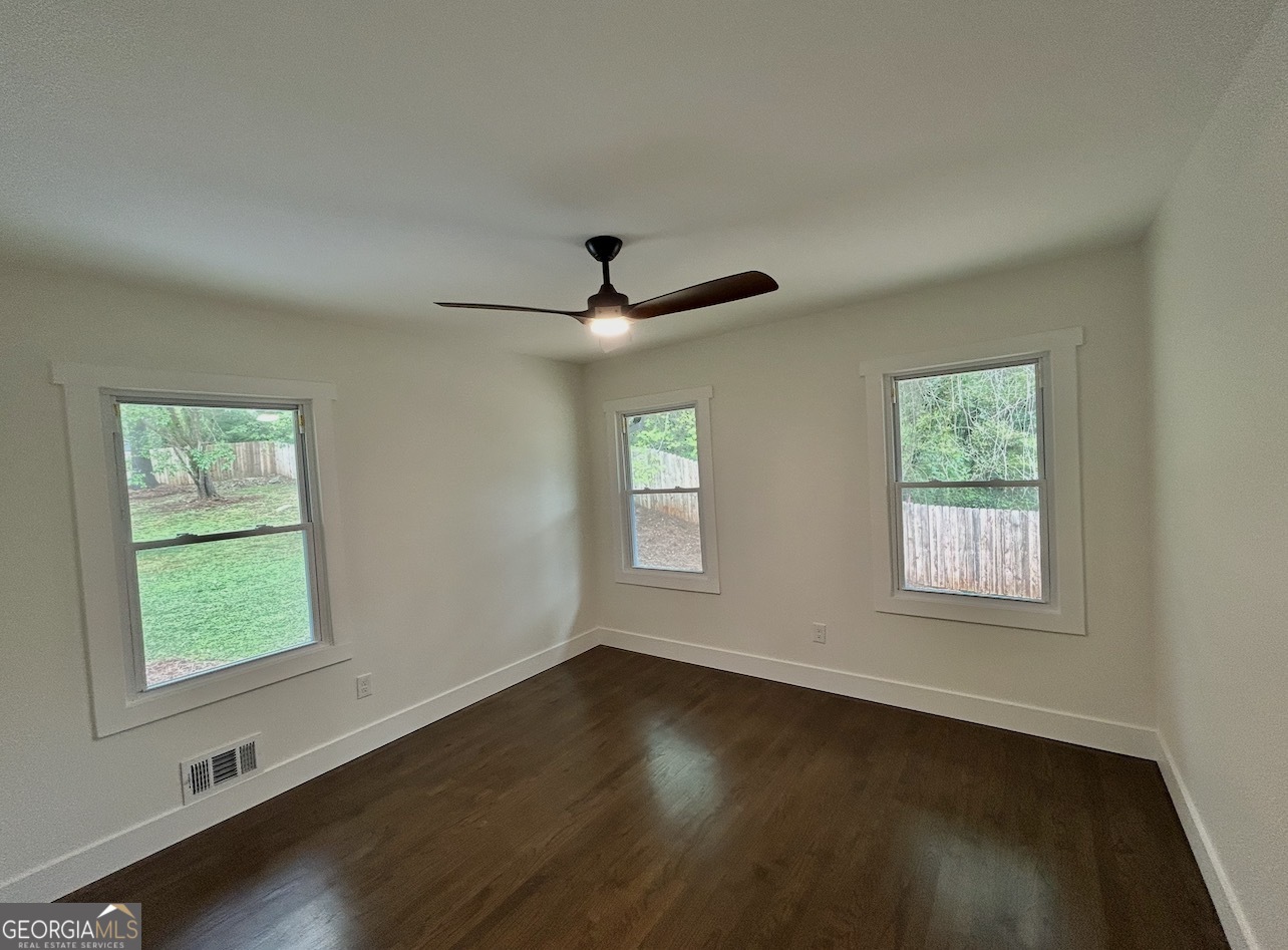 1742 Constitution Road Southeast Atlanta, GA 30316 - Photo 15 of 32 a view of an empty room with wooden floor and a window