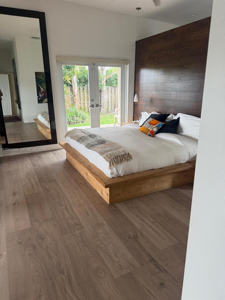 1251 Southwest 11th Terrace Boca Raton, FL 33486 - Photo 13 of 47 a bed sitting in a bedroom next to a window