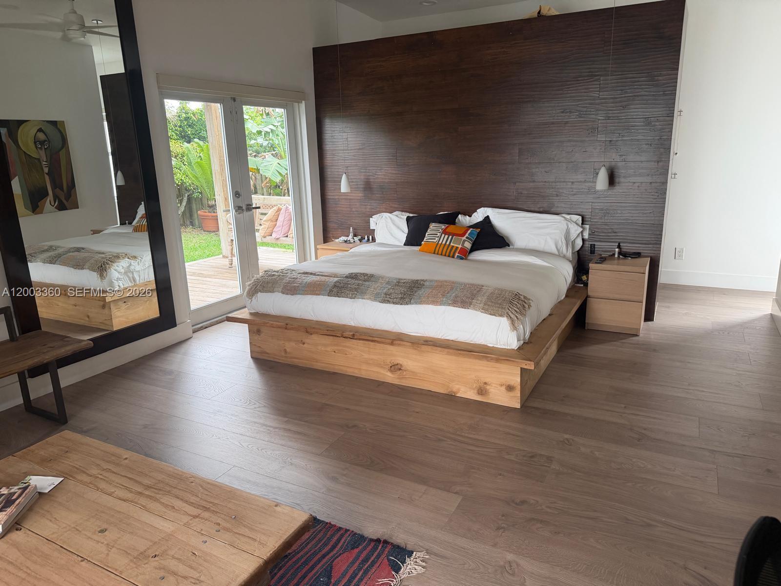 1251 Southwest 11th Terrace Boca Raton, FL 33486 - Photo 14 of 47 a bedroom with a bed and wooden floor