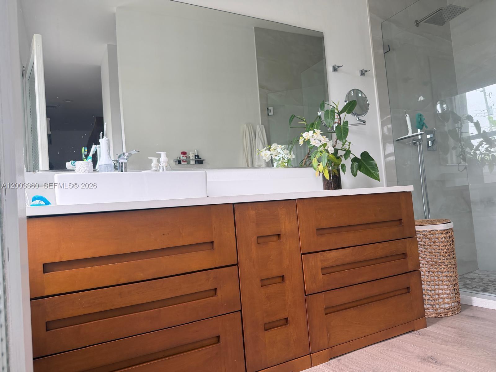 1251 Southwest 11th Terrace Boca Raton, FL 33486 - Photo 18 of 47 a view of bathroom with a potted plant on a sink and a mirror