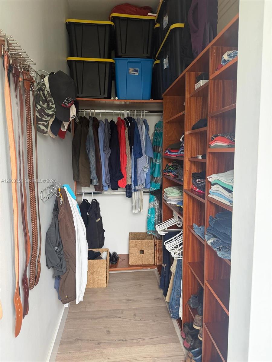 1251 Southwest 11th Terrace Boca Raton, FL 33486 - Photo 21 of 47 a view of walk in closet with clothes and shoes