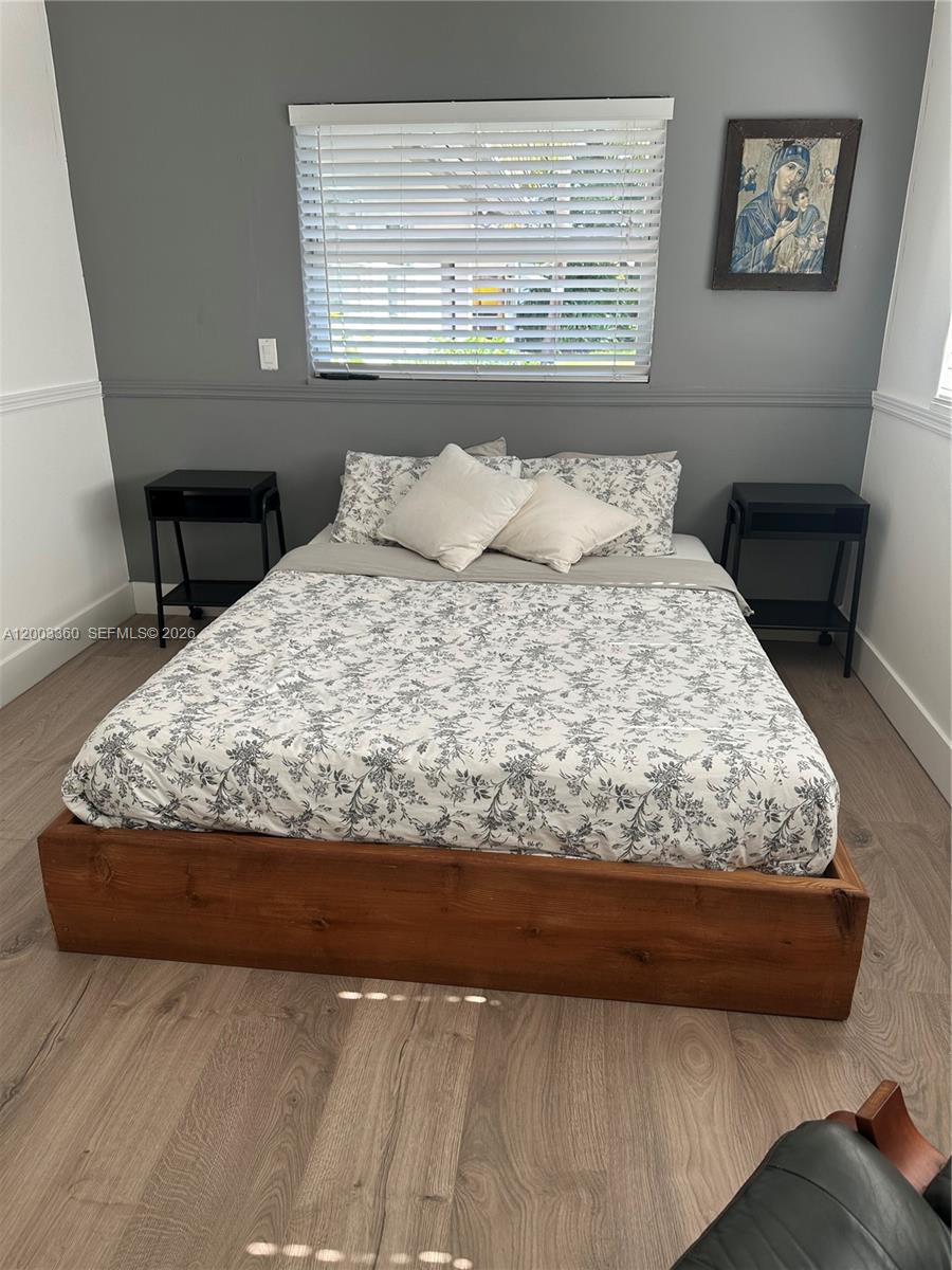 1251 Southwest 11th Terrace Boca Raton, FL 33486 - Photo 27 of 47 a bed sitting in a bedroom next to a window
