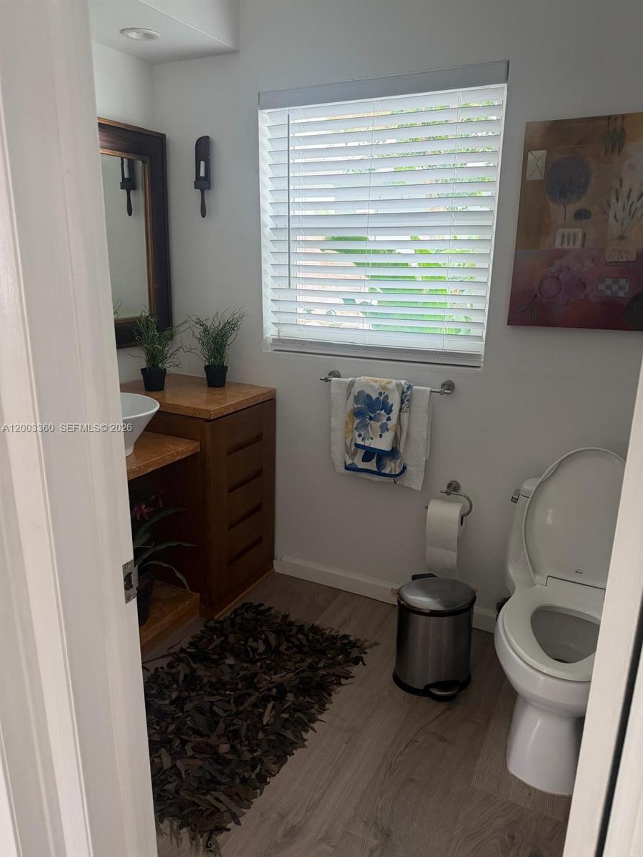 1251 Southwest 11th Terrace Boca Raton, FL 33486 - Photo 30 of 47 a bathroom with a toilet a sink and a window