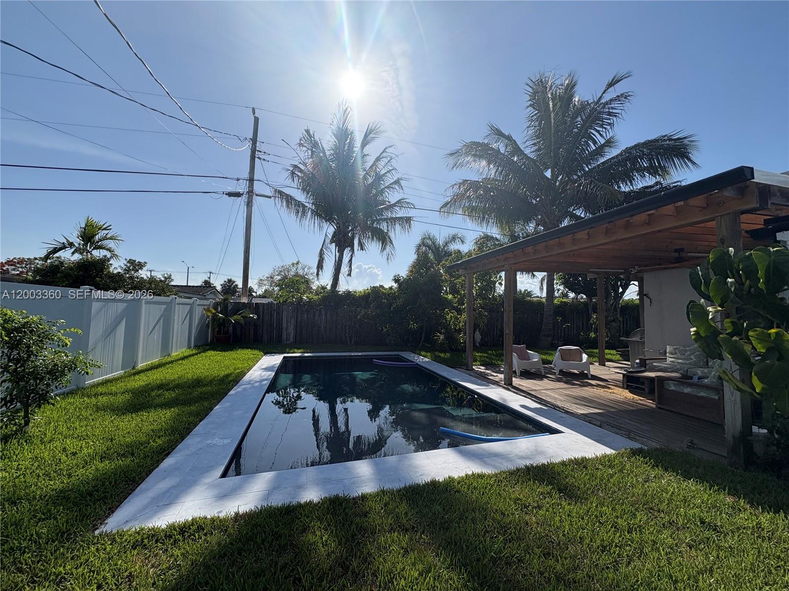 1251 Southwest 11th Terrace Boca Raton, FL 33486 - Photo 34 of 47 a view of a backyard with plants and a patio