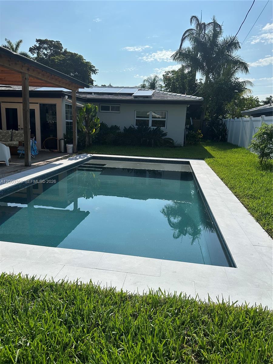 1251 Southwest 11th Terrace Boca Raton, FL 33486 - Photo 36 of 47 a view of swimming pool with a yard and plants