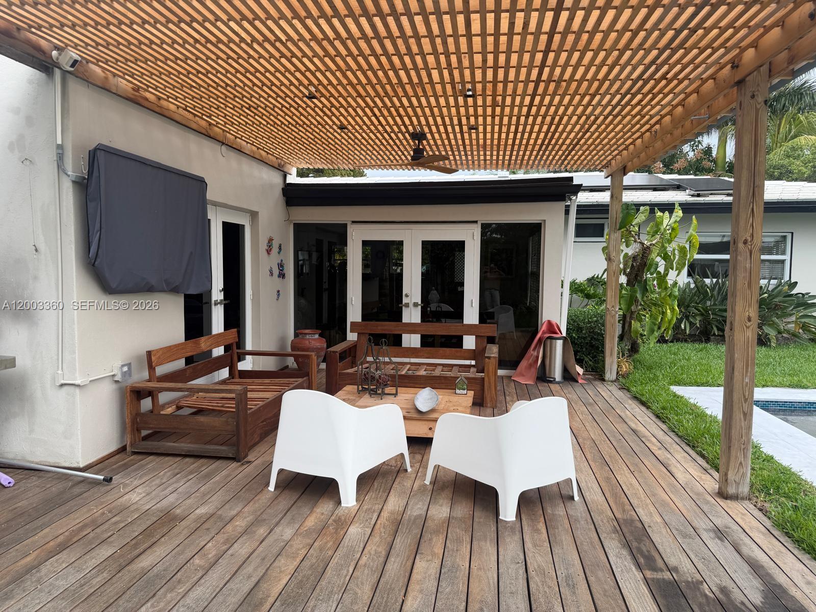 1251 Southwest 11th Terrace Boca Raton, FL 33486 - Photo 38 of 47 a view of a patio with table and chairs potted plants with wooden floor