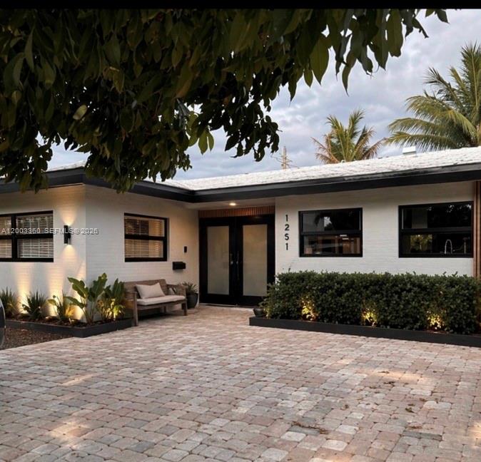1251 Southwest 11th Terrace Boca Raton, FL 33486 - Photo 4 of 47 a front view of a house with lots of green space and outdoor seating