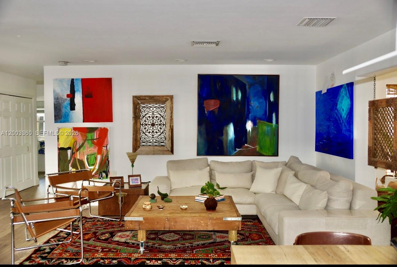 1251 Southwest 11th Terrace Boca Raton, FL 33486 - Photo 5 of 47 a living room with furniture and painting on the wall