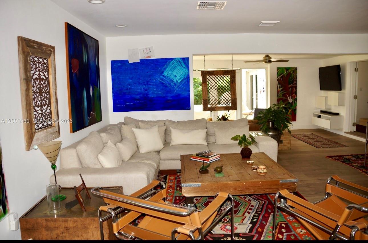 1251 Southwest 11th Terrace Boca Raton, FL 33486 - Photo 6 of 47 a living room with furniture a flat screen tv and a floor to ceiling window
