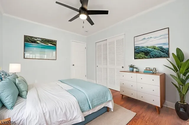 a bedroom with a bed and a potted plant