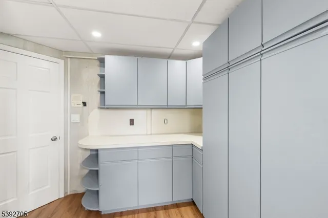 a room view with a sink a mirror and a shower