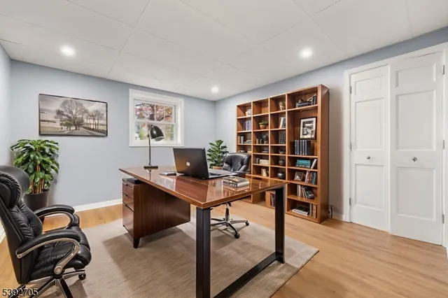 a view of a workspace with furniture and a window