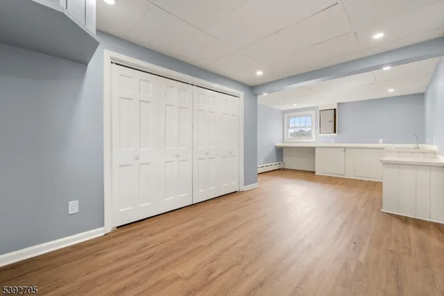 a view of a kitchen with wooden floor and a sink
