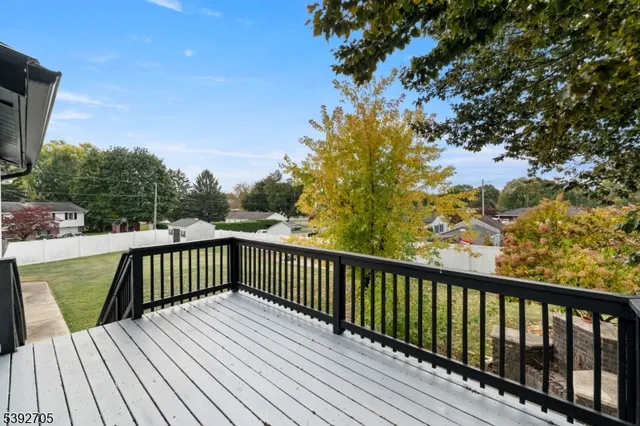 a view of balcony with wooden floor and fence