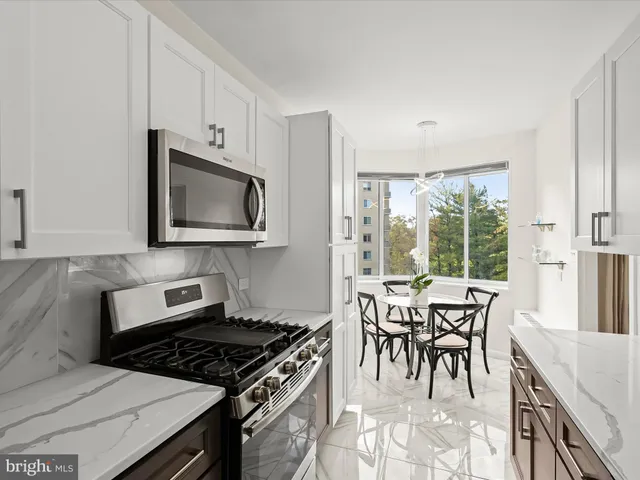 a kitchen with stainless steel appliances a stove a sink and a microwave
