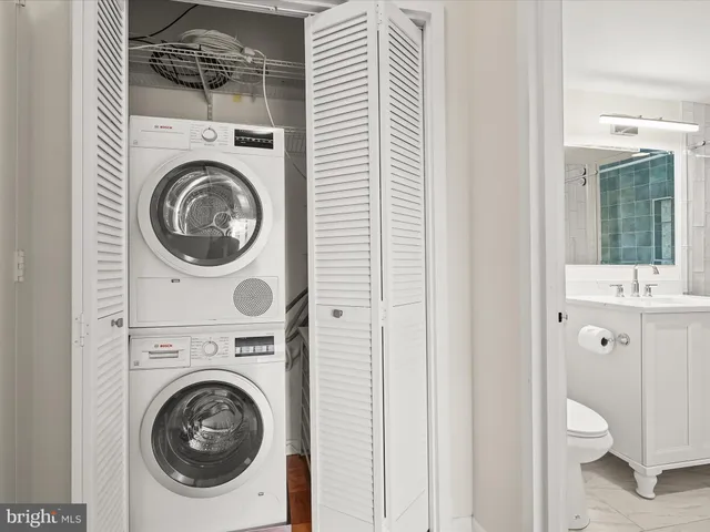 a bathroom with a granite countertop sink mirror and toilet