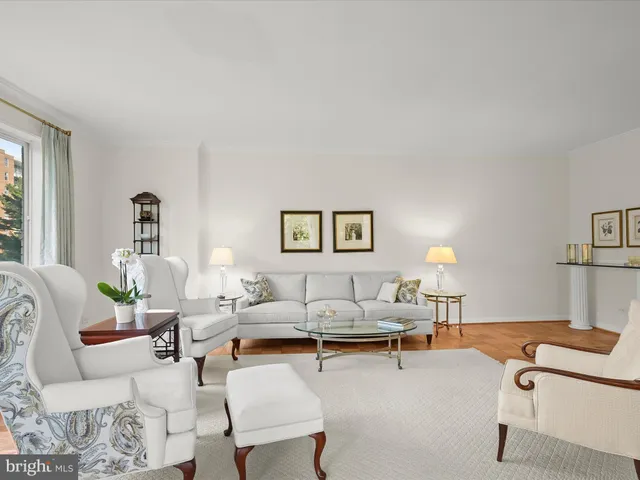 a living room with furniture and a lamp