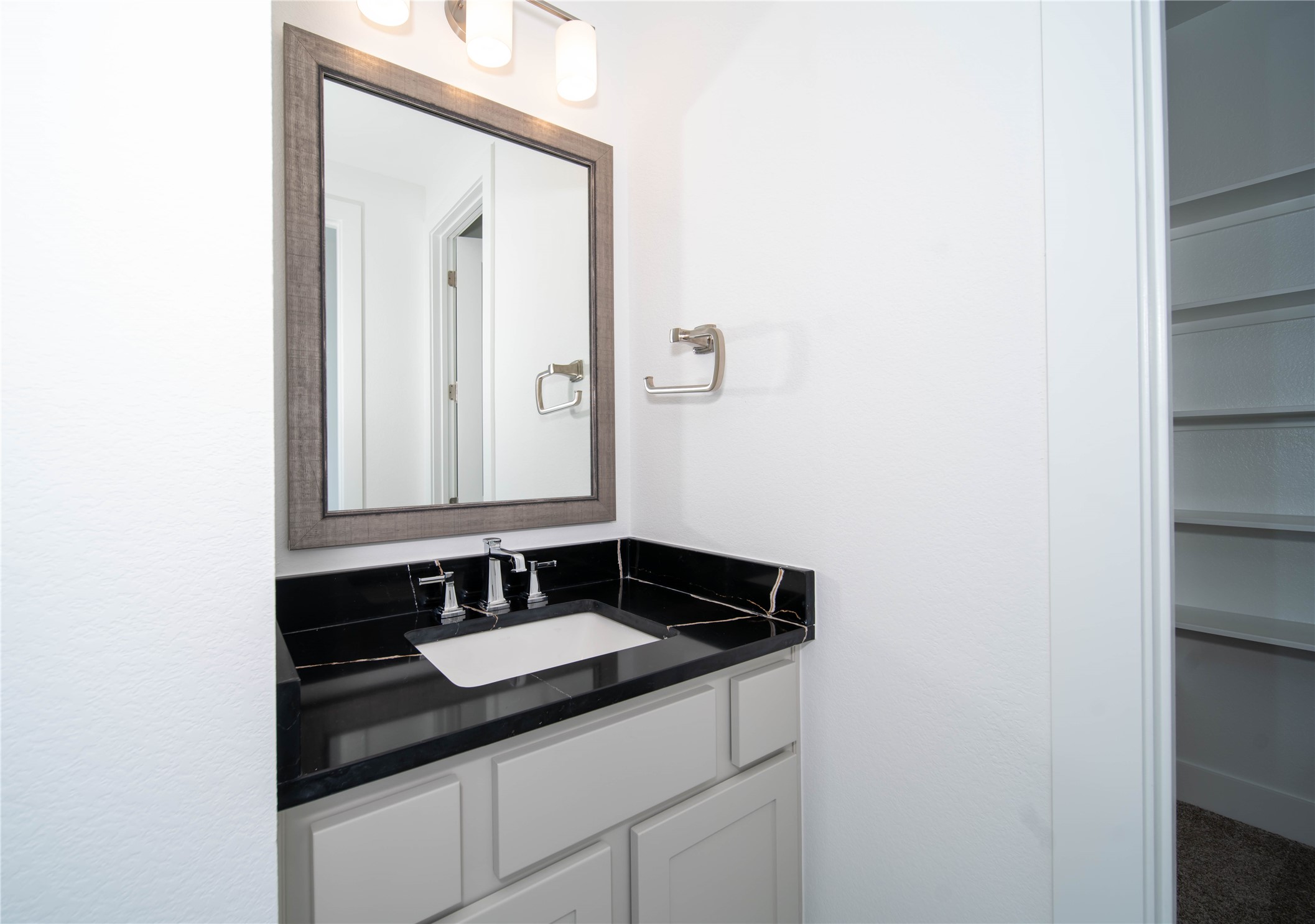 2029 Varese Path Leander, TX 78641 - Photo 15 of 32 a bathroom with a sink and a mirror