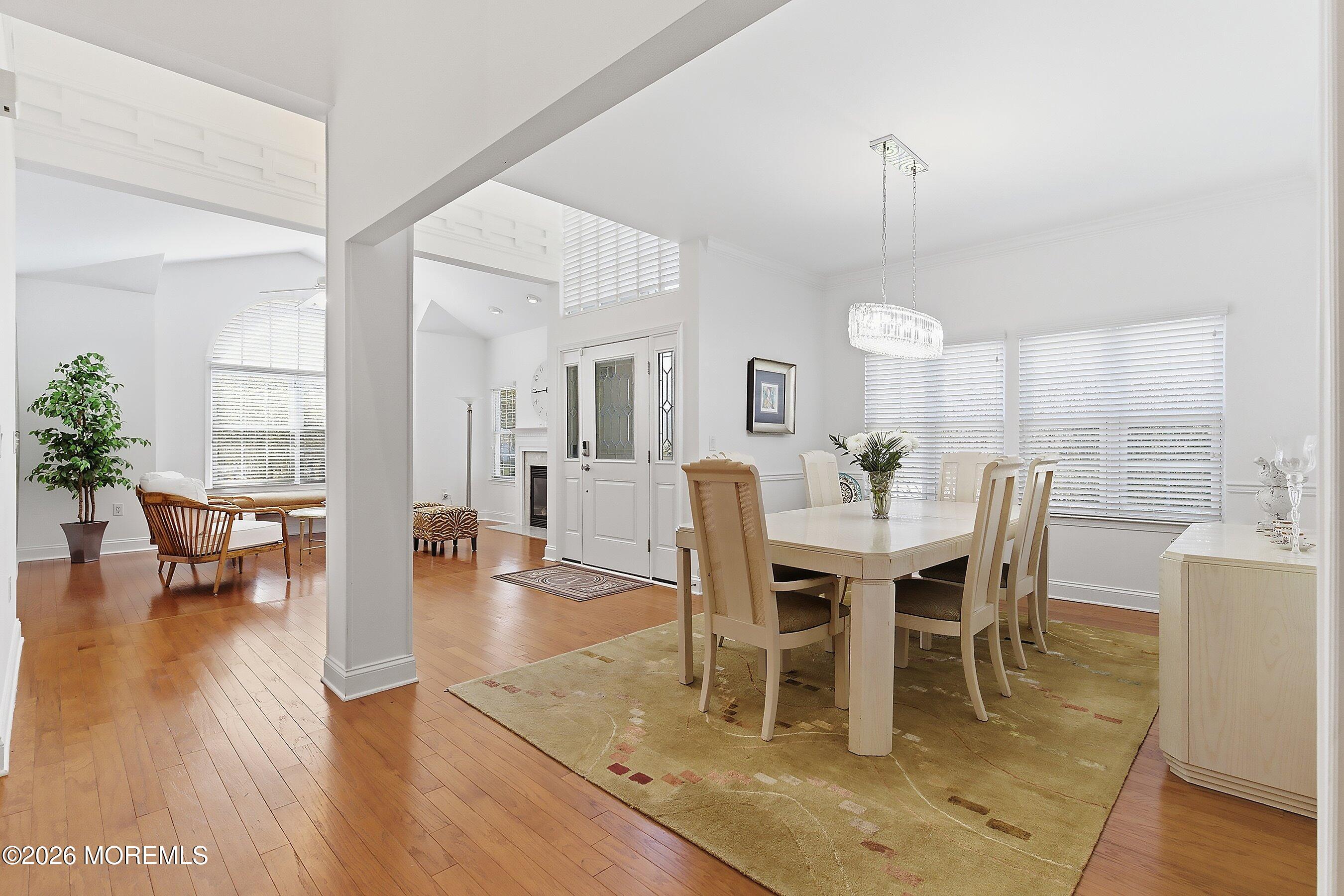 9 Margate Way Waretown, NJ 08758 - Photo 22 of 59 a view of a dining room and livingroom with furniture wooden floor a rug a painting and a chandelier