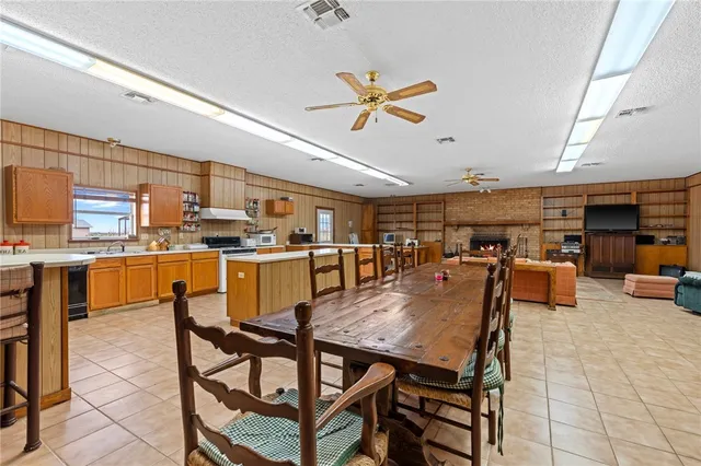 a bathroom with a double vanity sink a large mirror and a bathtub
