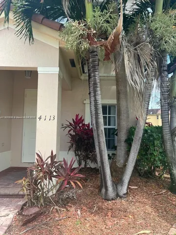 a view of a house with a tree in a yard