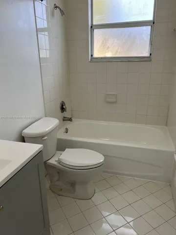 a bathroom with a toilet a sink and a bathtub