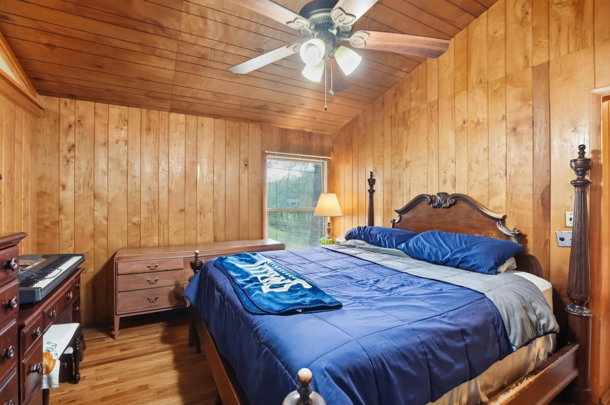 1071 Simms Heights Road Kingston Springs, TN 37082 - Photo 22 of 38 a bedroom with a bed and a chandelier