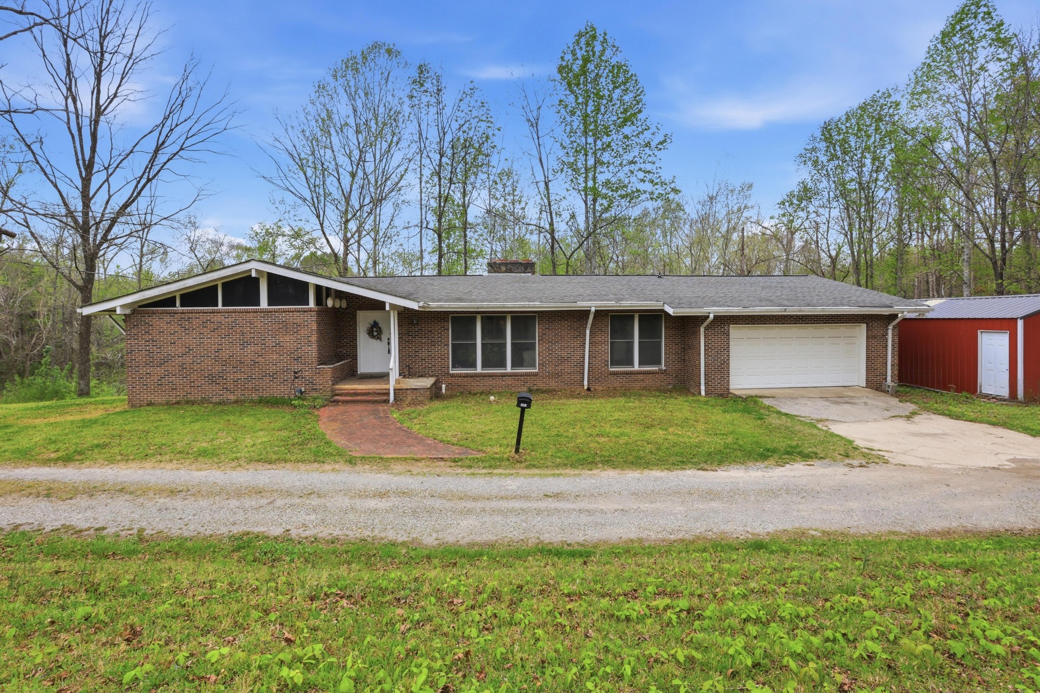 1071 Simms Heights Road Kingston Springs, TN 37082 - Photo 3 of 38 a front view of a house with a yard and garage