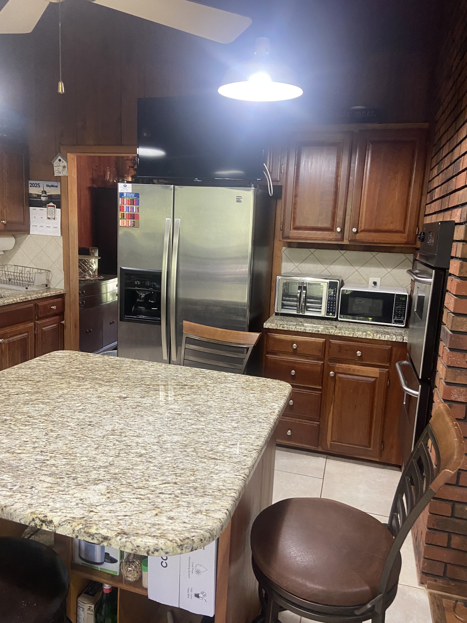 1071 Simms Heights Road Kingston Springs, TN 37082 - Photo 9 of 31 a kitchen with stainless steel appliances granite countertop a sink wooden cabinets and a granite counter tops