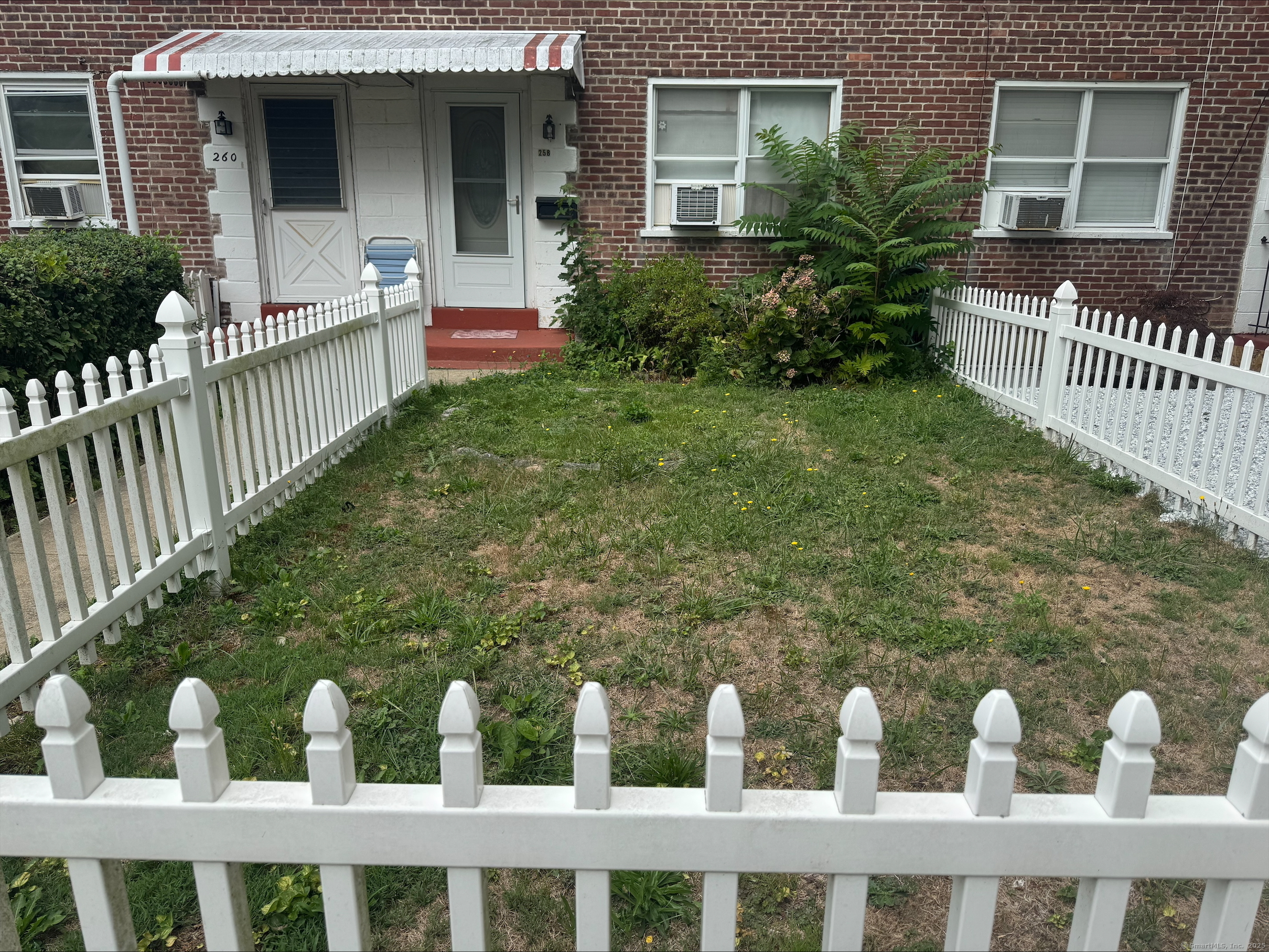 55 Court D, Unit 258 Bridgeport, CT 06610 - Photo 1 of 1 a front view of a house with iron fence
