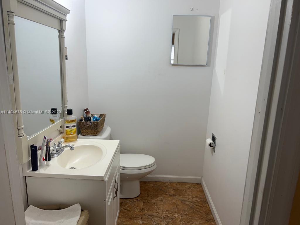 1329 Sunrise Road West Palm Beach, FL 33406 - Photo 11 of 28 a white toilet sitting next to a bathroom sink