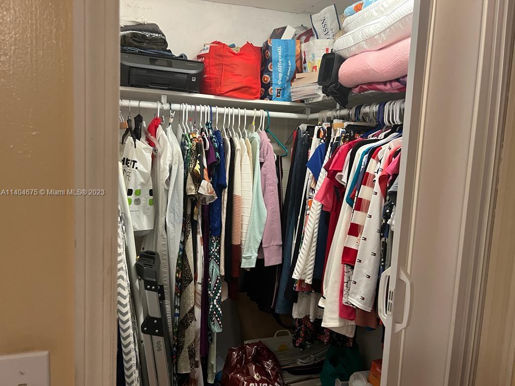 1329 Sunrise Road West Palm Beach, FL 33406 - Photo 12 of 28 a view of walk in closet with clothes
