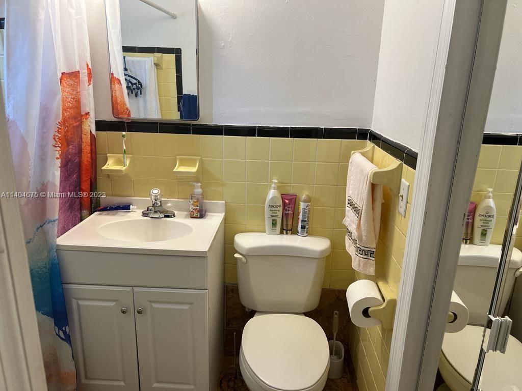 1329 Sunrise Road West Palm Beach, FL 33406 - Photo 14 of 28 a bathroom with a toilet sink and mirror