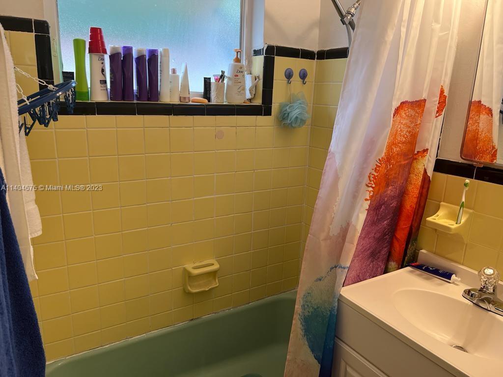 1329 Sunrise Road West Palm Beach, FL 33406 - Photo 15 of 28 a bathroom with a sink and a mirror