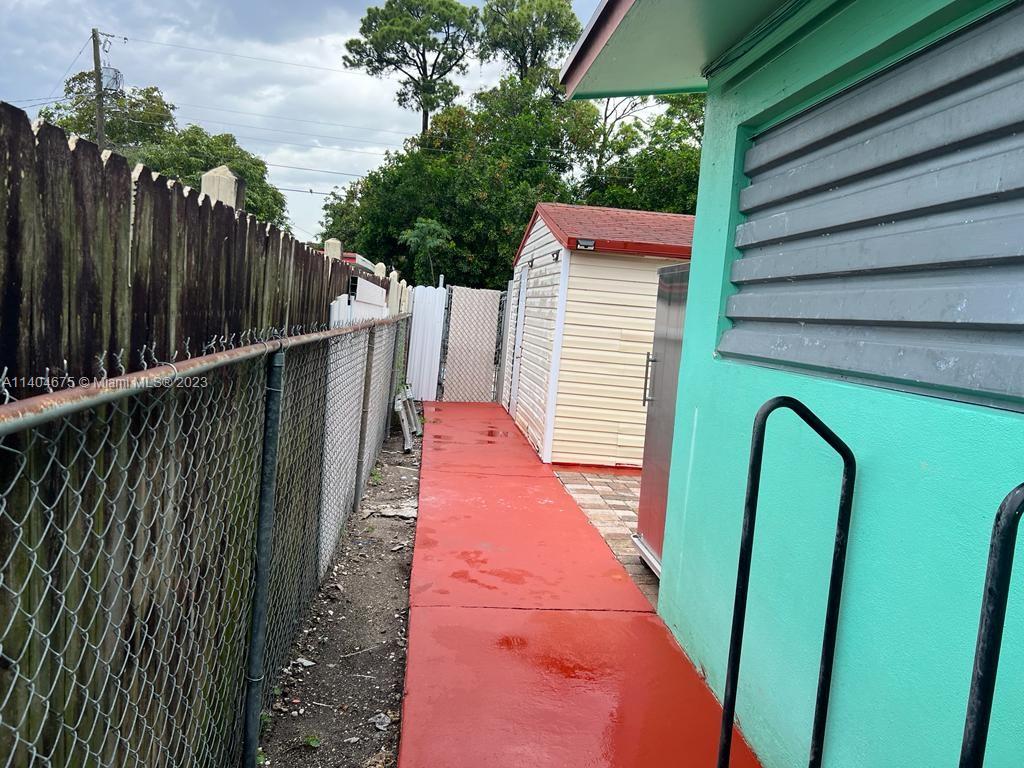 1329 Sunrise Road West Palm Beach, FL 33406 - Photo 17 of 28 a view of balcony with wooden floor and fence