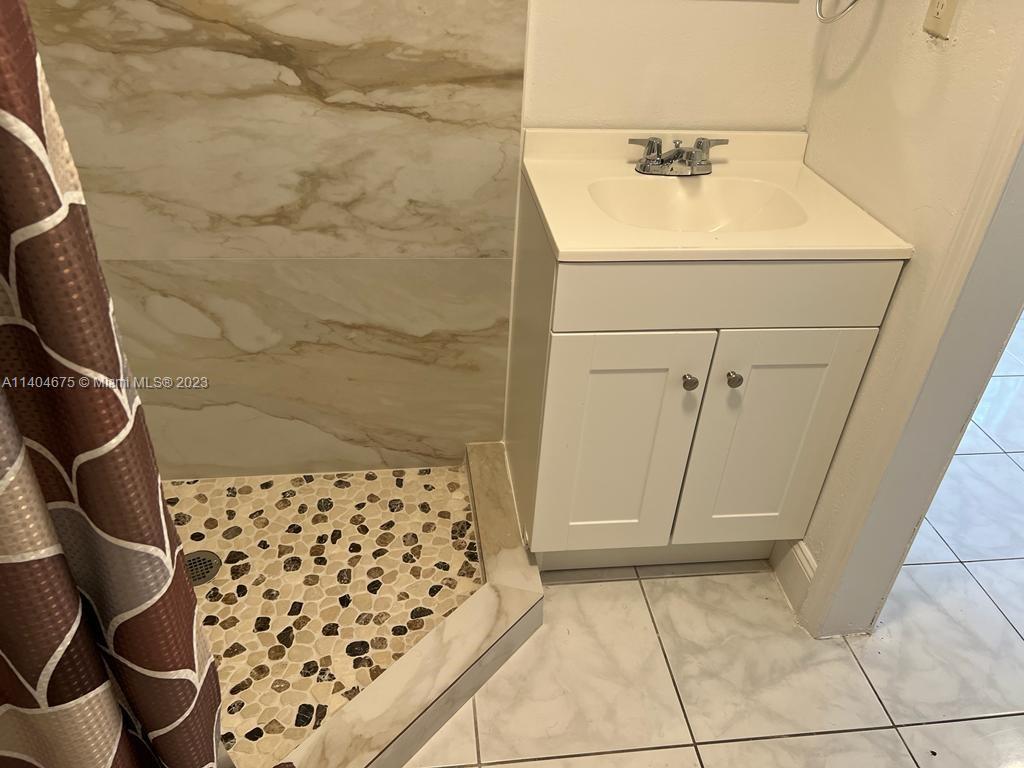 1329 Sunrise Road West Palm Beach, FL 33406 - Photo 27 of 28 a bathroom with a sink and a shower