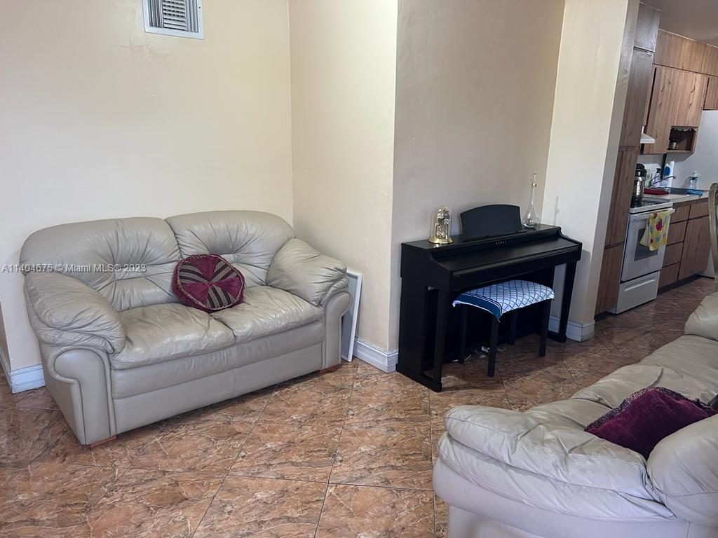 1329 Sunrise Road West Palm Beach, FL 33406 - Photo 4 of 28 a living room with furniture and a fireplace