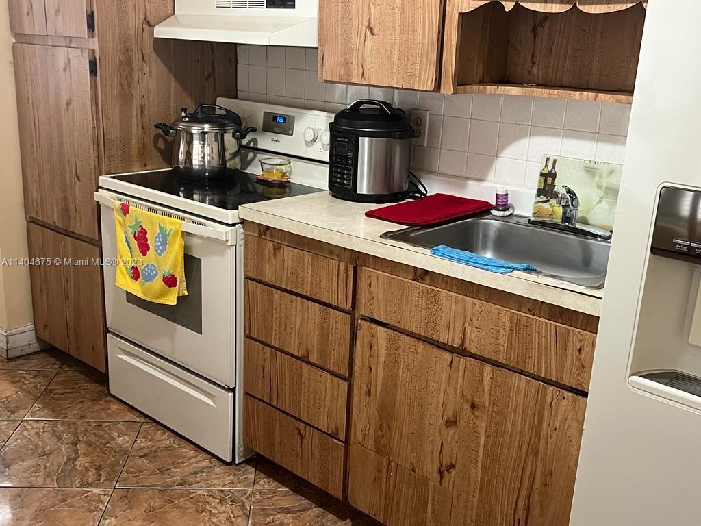 1329 Sunrise Road West Palm Beach, FL 33406 - Photo 6 of 28 a kitchen with sink cabinets and appliances